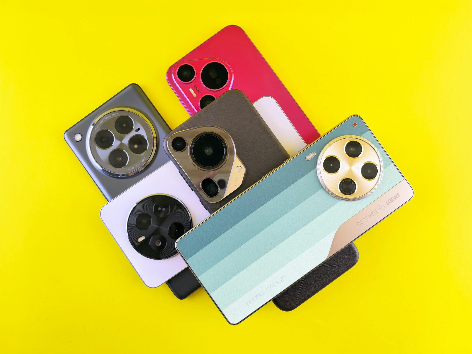 A collection of diverse smartphone designs on a vibrant yellow backdrop.